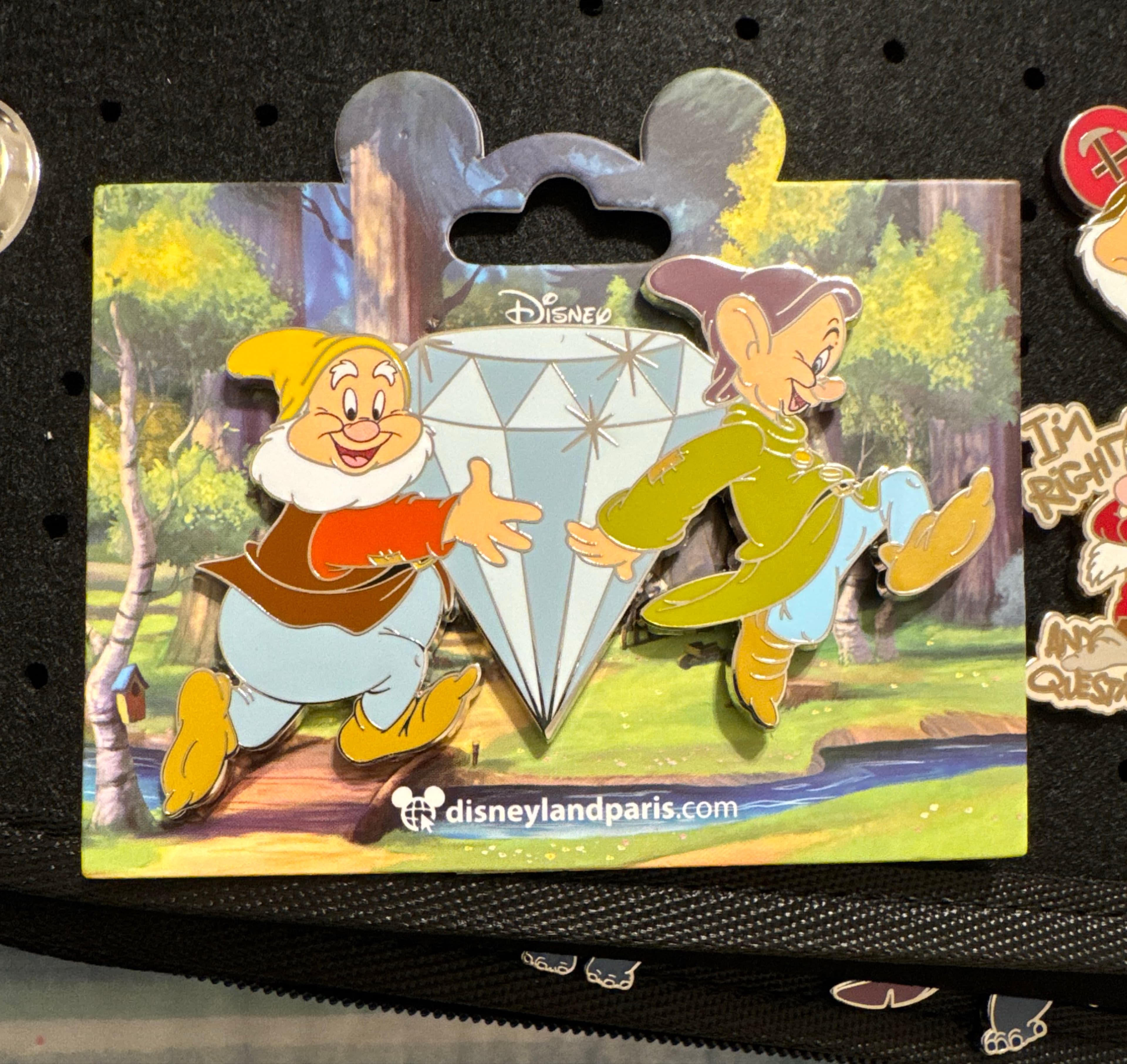 Happy and Dopey holding a big diamond