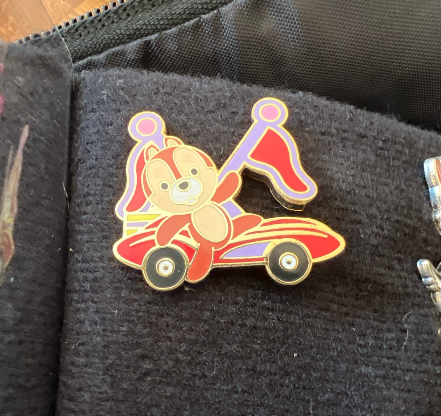 Chip Waving in Red Race Car with Red and Purple Flags