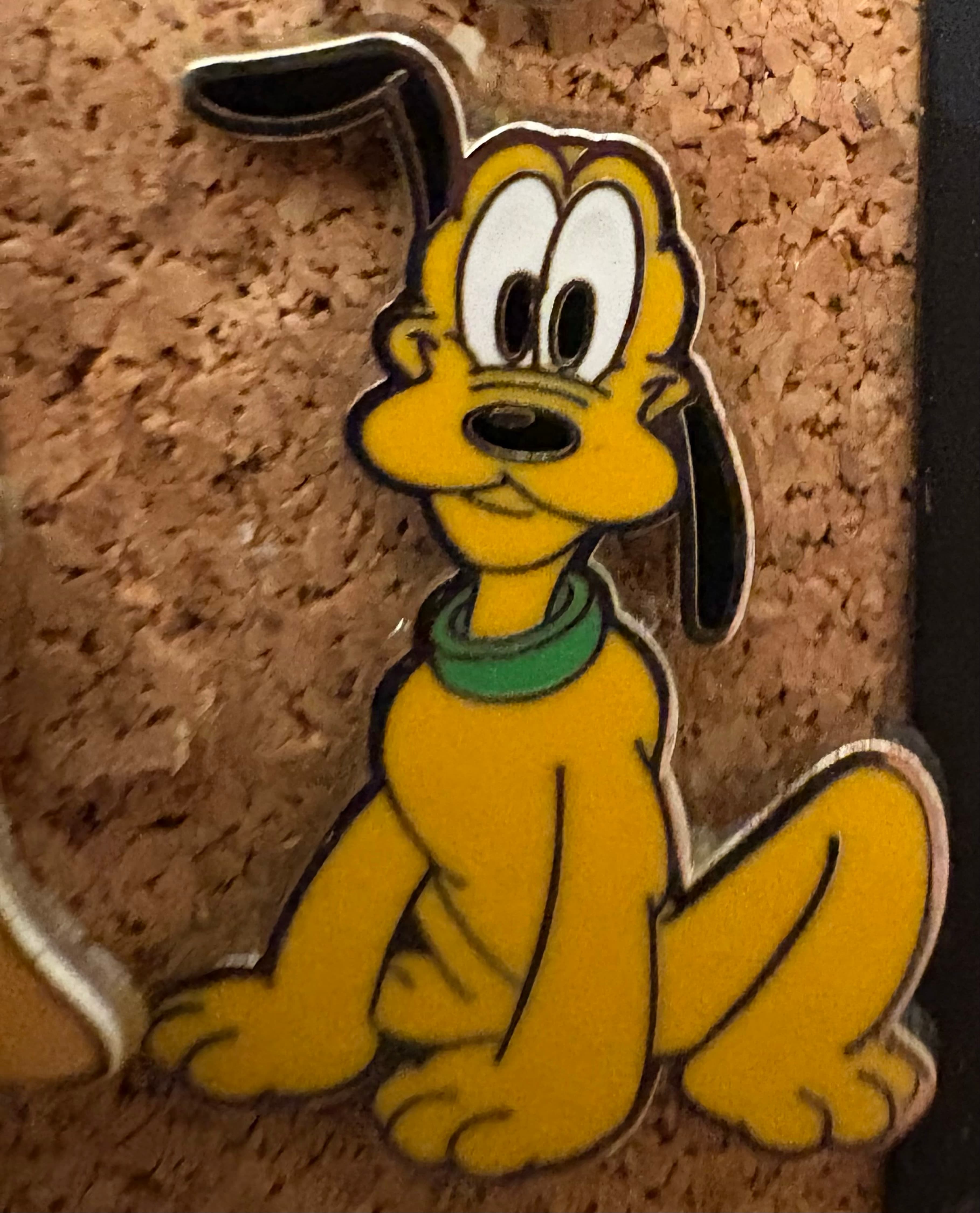Pluto Sitting with Ear Raised front