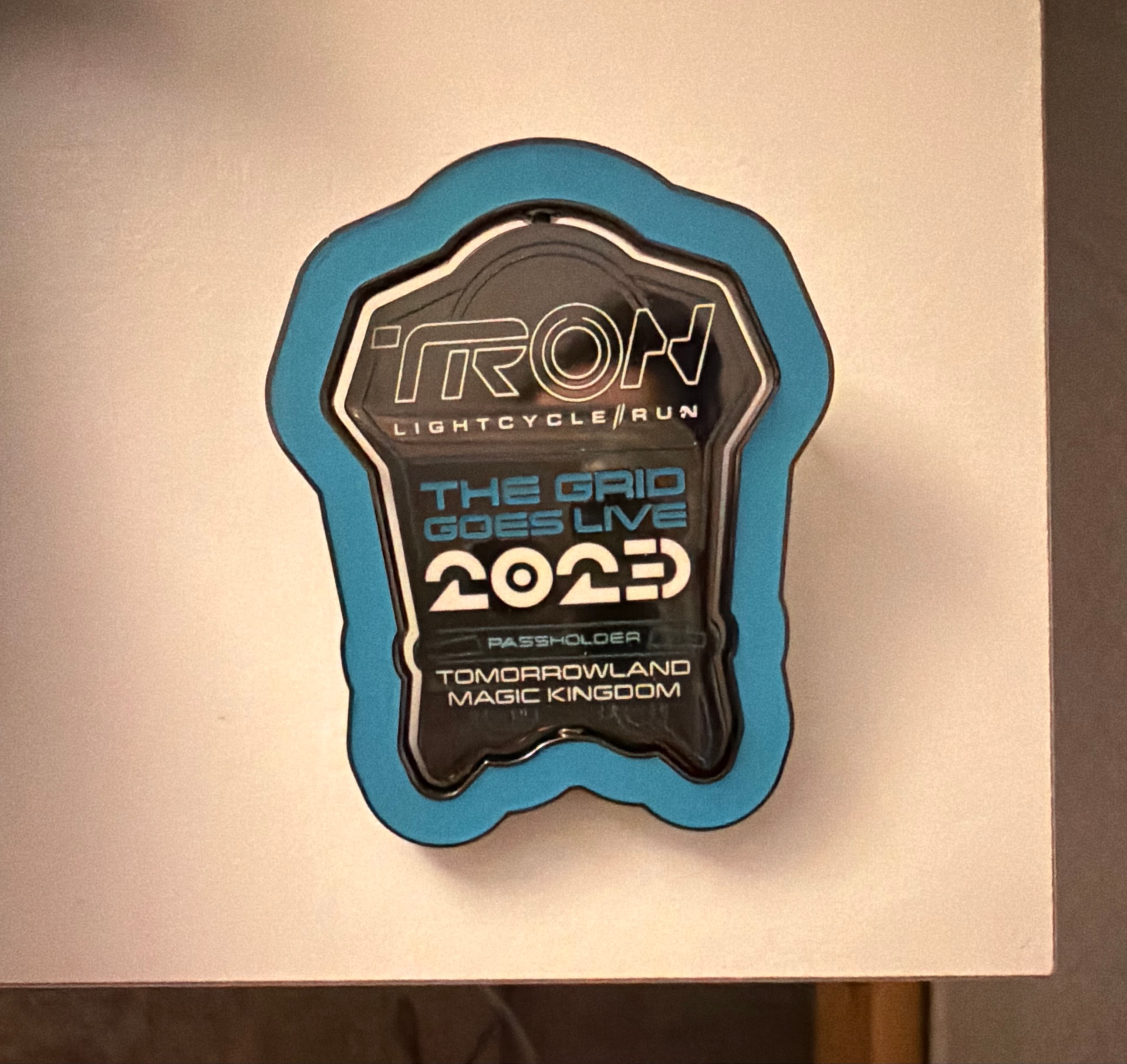 TRON Lightcycle Run The Grid Goes Live 2023 Annual Passholder Spinner Glow in the Dark Pin front