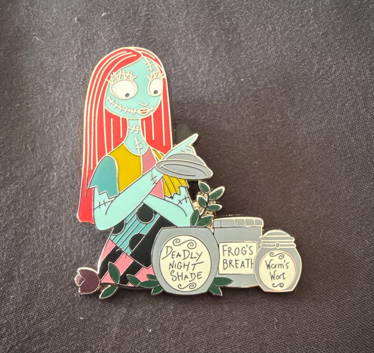 Sally with Jars of Deadly Night Shade, Frog's Breath, and Worm's Wort front